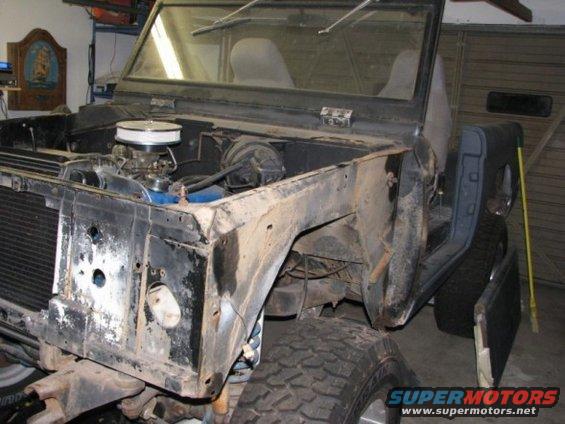 1976 Ford Bronco front end with engine exposed, undergoing restoration