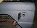 1976 Ford Bronco - Close-up of the rear fender and open fuel filler door on a 1976 Ford Bronco, ready for paint.