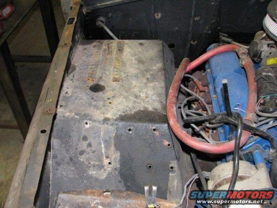 Engine bay detail showing blue valve covers and red hoses