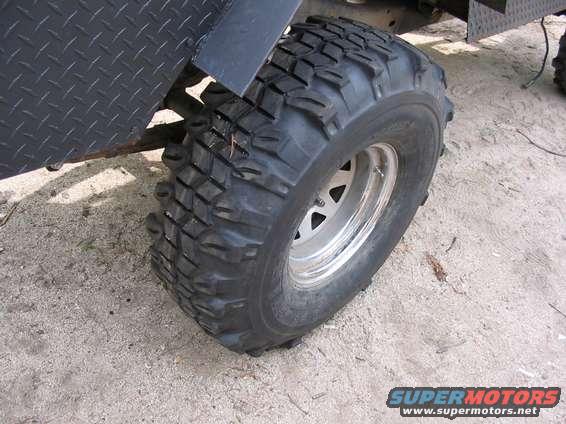 close-up of a large off-road tire and diamond plate fender on a vehicle