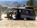 1996 Ford Bronco - The stripped body of a Ford Bronco sits on the ground, with another vehicle visible in the background.