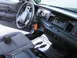 2001 Ford Crown Victoria - The interior of a 2001 Ford Crown Victoria, the driver's side seat, steering wheel, and dashboard with a radio.