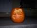 1990 Ford Escort - A carved pumpkin sits on a porch, illuminated by an unseen light source.