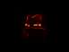 1990 Ford Escort - A carved jack-o'-lantern glows with an eerie orange light against a black background.