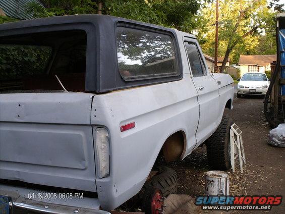 White 1979 Ford Bronco, 3q-front view, primer paint, black hardtop