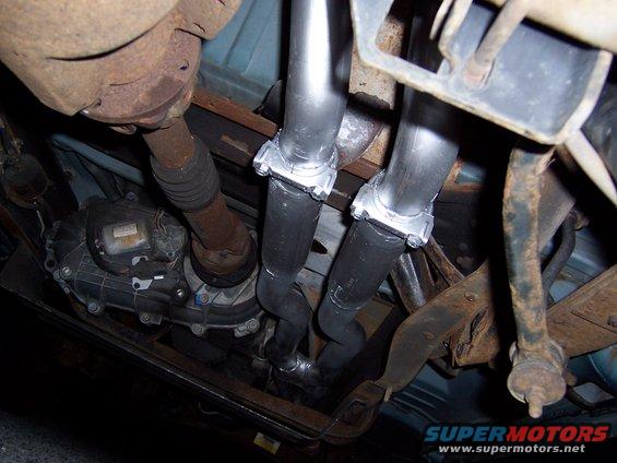 Underbody view of a dual exhaust system with new pipes and clamps