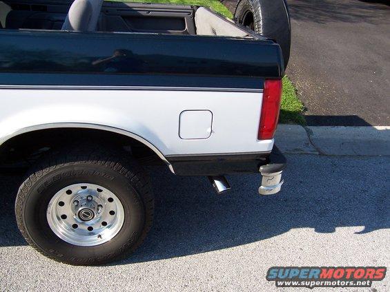 Two-tone white and dark green Ford Bronco rear quarter panel with a spare tire mounted externally