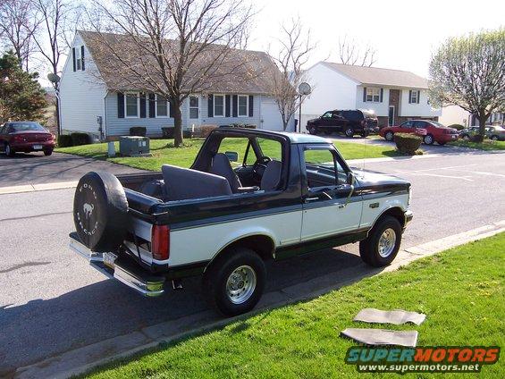 Green and white 1995 Ford Bronco with spare tire on rear
