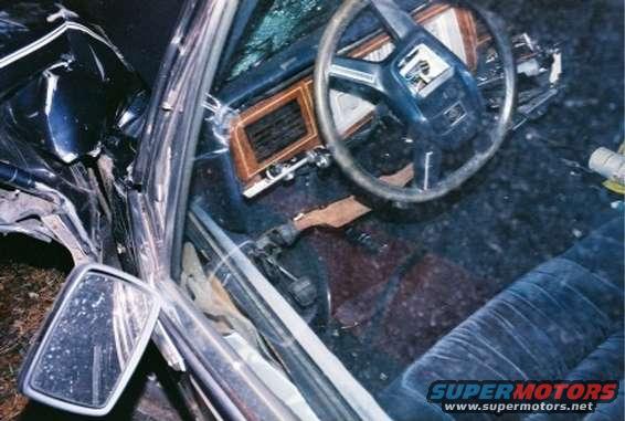 1988 Mercury Grand Marquis interior after accident, showing damaged dashboard and steering wheel