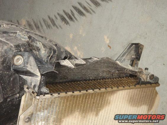 Close-up of a damaged radiator with black plastic housing
