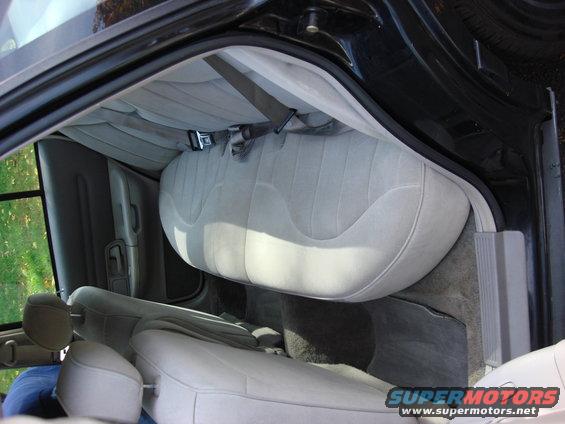 Gray cloth rear bench seat and front seats in a car interior, viewed from above