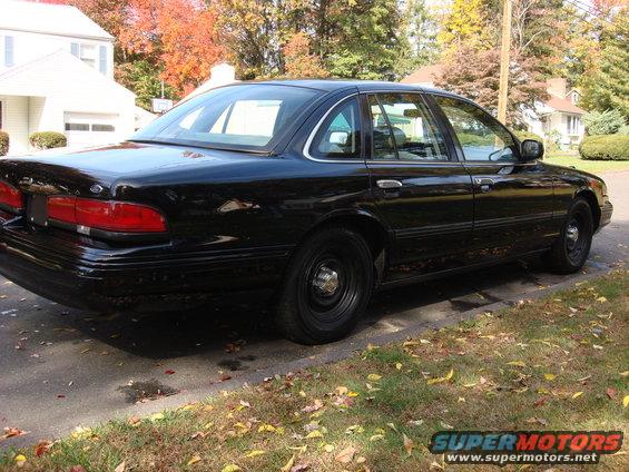 Black 2003 Ford Crown Victoria sedan parked on a residential street