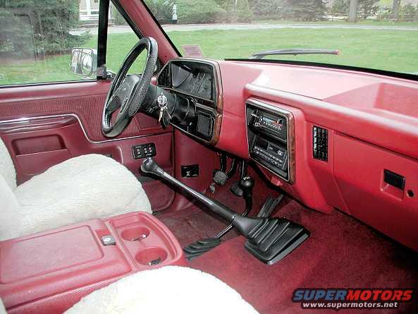 Nice view of the front seat with the sweet thick sheepskin seat covers, AM/FM Cassette stereo, and the huge 5 speed stick shift.