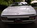 1991 Ford Probe - Front view of a white 1991 Ford Probe, its iconic pop-up headlights and Ford badging.