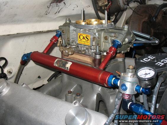 Close-up of a C&S Specialties carburetor with red fuel lines and a Mallory fuel pressure regulator