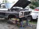 1979 Ford Bronco - This truck is undergoing repairs with its front end disassembled and supported on jack stands.