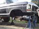 1979 Ford Bronco - This Ford truck is raised on jack stands, showing its undercarriage and missing front grille.