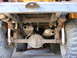 1974 Ford Bronco - Vehicle's rear undercarriage with dual exhaust system and suspension components visible.