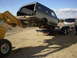 1996 Ford Bronco - A gray SUV is being lifted onto a trailer by a yellow loader, with another SUV visible in the background.