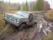 1988 Chevrolet Blazer - A 1988 Chevrolet Blazer navigates a treacherous muddy trail, with the driver looking out the window.