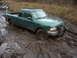 1988 Chevrolet Blazer - This green pickup truck is stuck deep in the mud, its front tires submerged and a brush guard attached.