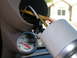 2001 Ford F-350 - Installing a new gauge in the vehicle's interior, showing wiring and a light bulb.