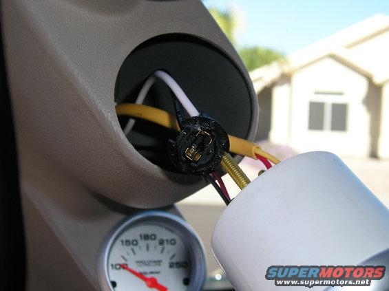 Gauge cluster with exposed wiring and a white housing