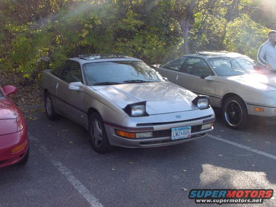 Silver 1991 Ford Probe with pop-up headlights parked next to another car