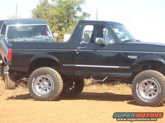 Black 1992 Ford Bronco side view with another vehicle behind it