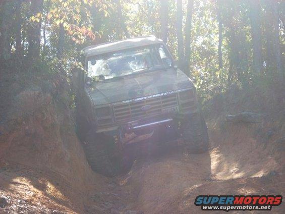 1992 Ford Bronco climbing a muddy hill
