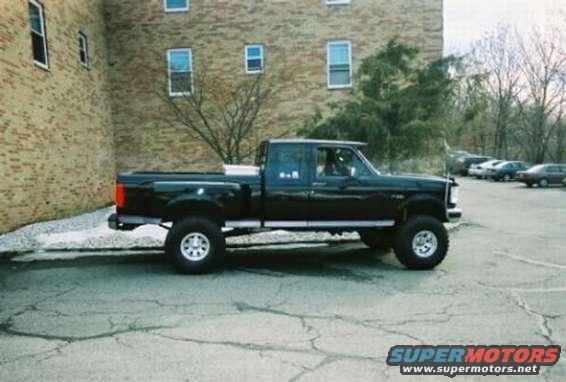 black pickup truck parked outside brick building