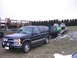 1998 Chevrolet Tahoe - 1998 Chevrolet Tahoe in 3q-front view is seen towing a trailer with snowmobiles.
