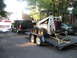1998 Chevrolet Tahoe - 1998 Chevrolet Tahoe is seen towing a trailer loaded with a skid steer loader.