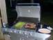 1971 Ford Ranchero - Steaks and asparagus are grilling on a stainless steel gas grill outdoors at night.