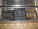 1989 Ford F-250 - A toolbox in a truck bed contains a tray with hardware and two curved chrome pipes.
