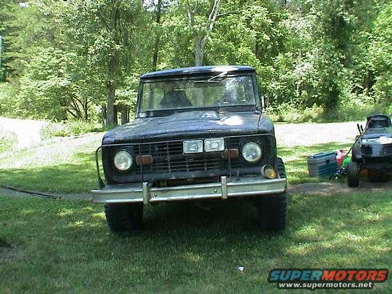 1972 Ford Bronco front view, parked on grass with trees in background