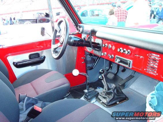 Red interior with manual shifters and aftermarket radio