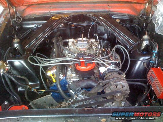 Engine bay with V8 engine, carburetor, and distributor
