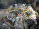 1988 Ford Bronco - Close-up view of a vehicle's engine bay, a carburetor and yellow spark plug wires.