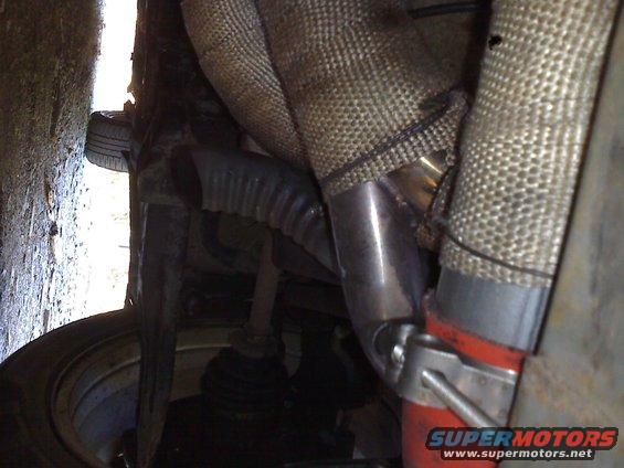 Exhaust manifold and piping with heat wrap and red hose clamp