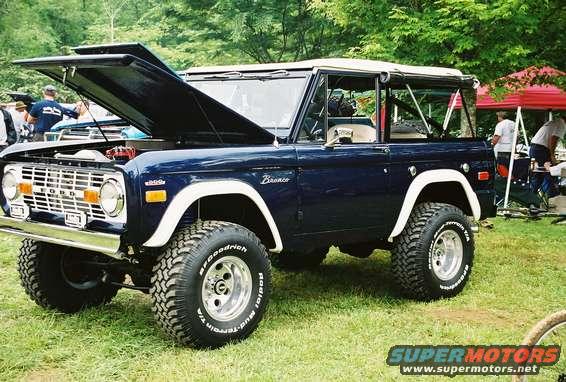 Dark blue 1972 Ford Bronco with hood open, showing engine