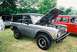 1972 Ford Bronco - Gray 1972 Ford Bronco shown with its hood open at an outdoor event.