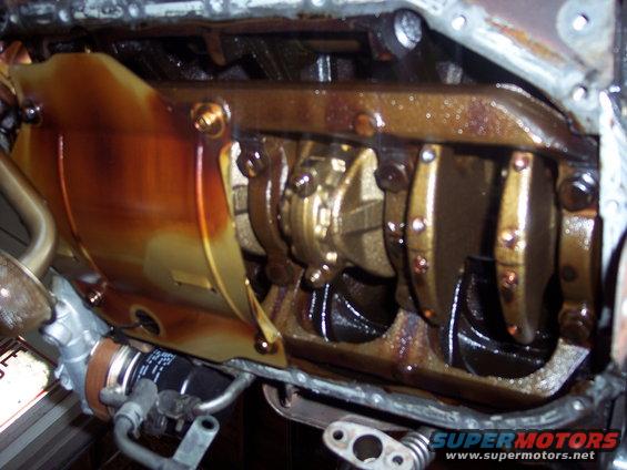 Engine oil pan removed, showing crankshaft and connecting rod bearings