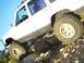 1998 Jeep Cherokee - A white 1998 Jeep Cherokee navigates a rocky terrain, its off-road capabilities.