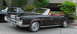 1969 Mercury Marquis - A black 1969 Mercury Marquis convertible with a red interior is parked next to another vehicle.