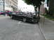 1969 Mercury Marquis - A black 1969 Mercury Marquis convertible with a red interior is parked on a city street next to a sidewalk.