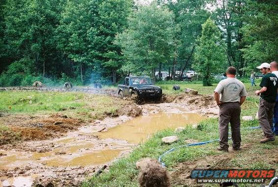 Black 1972 Ford Bronco driving through mud pit