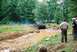 1972 Ford Bronco - A black 1972 Ford Bronco navigates a challenging mud obstacle during an off-road event.