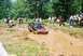 1972 Ford Bronco - A 1972 Ford Bronco navigates a muddy obstacle course with spectators watching from the sidelines.