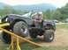 1972 Ford Bronco - A man sits in a modified 1972 Ford Bronco as it is positioned on an off-road ramp.